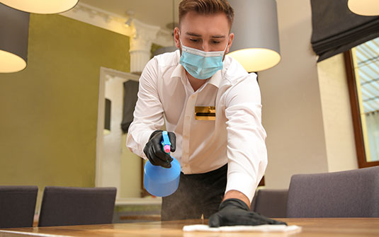 cleaning-staff-sanitzing-table-top_535x335px.jpg